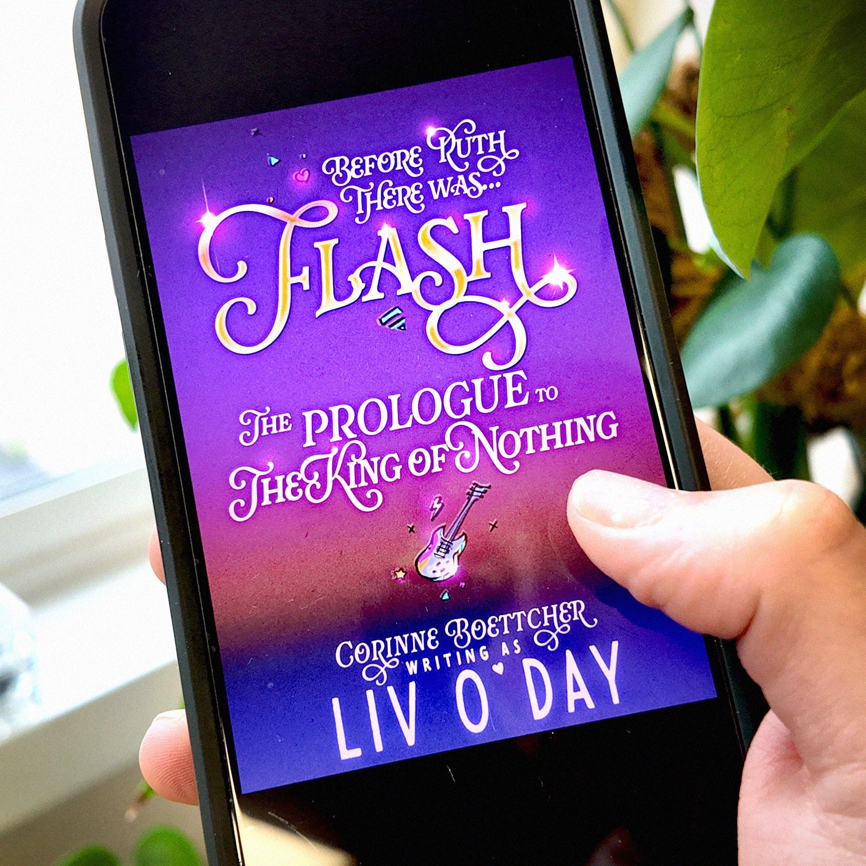 Hand holding a phone displaying a book cover with 'Flash' by Liv O'Day on a blurred natural background