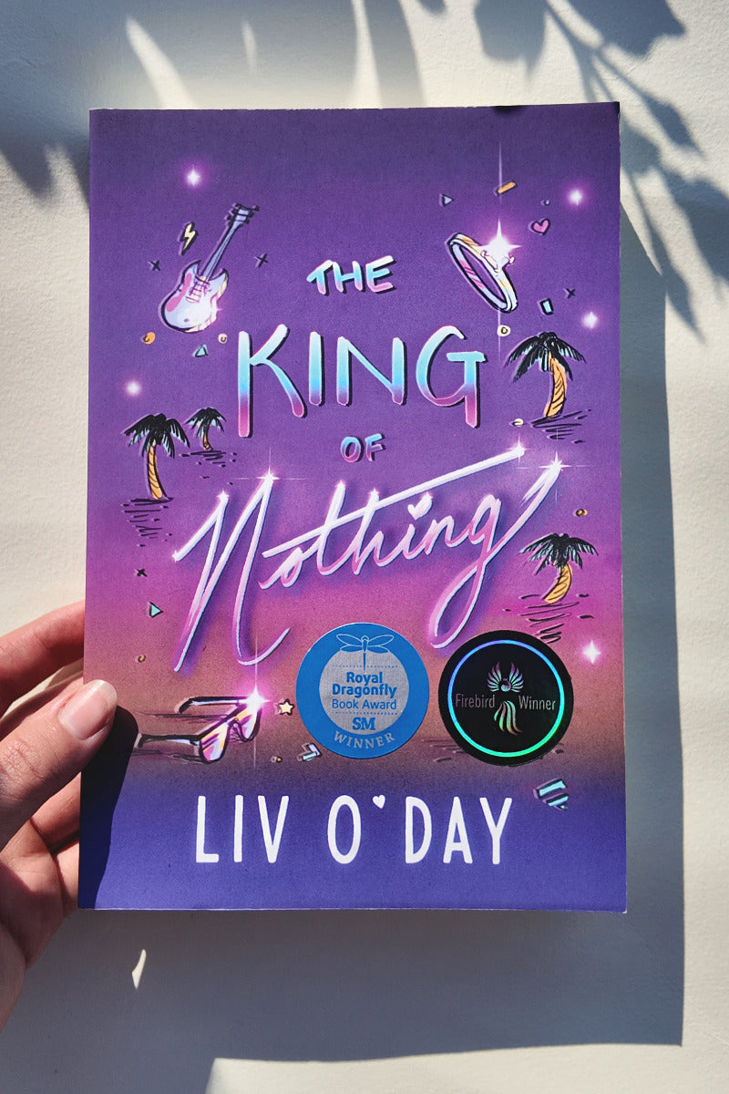 Book titled 'The King of Nothing' by Liv O'Day held against a light background